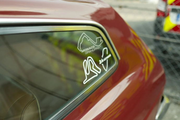 Car window with racing circuit stickers